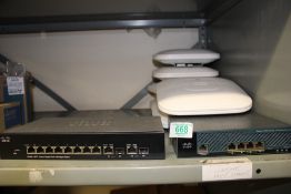 An unboxed Cisco managed switch: together with 6 unboxed alarms.