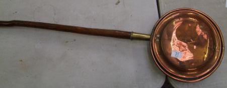 A copper and brass bed warming pan: