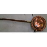 A copper and brass bed warming pan:
