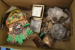 A mixed collection of items to include: small cuckoo clock, wind chimes, travel clock.