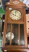 1920's Oak cased wall clock: key and pendulum present.