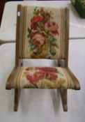 A Victorian gout stool/rocking footstool: with floral decoration to the fabric.