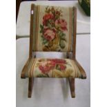 A Victorian gout stool/rocking footstool: with floral decoration to the fabric.