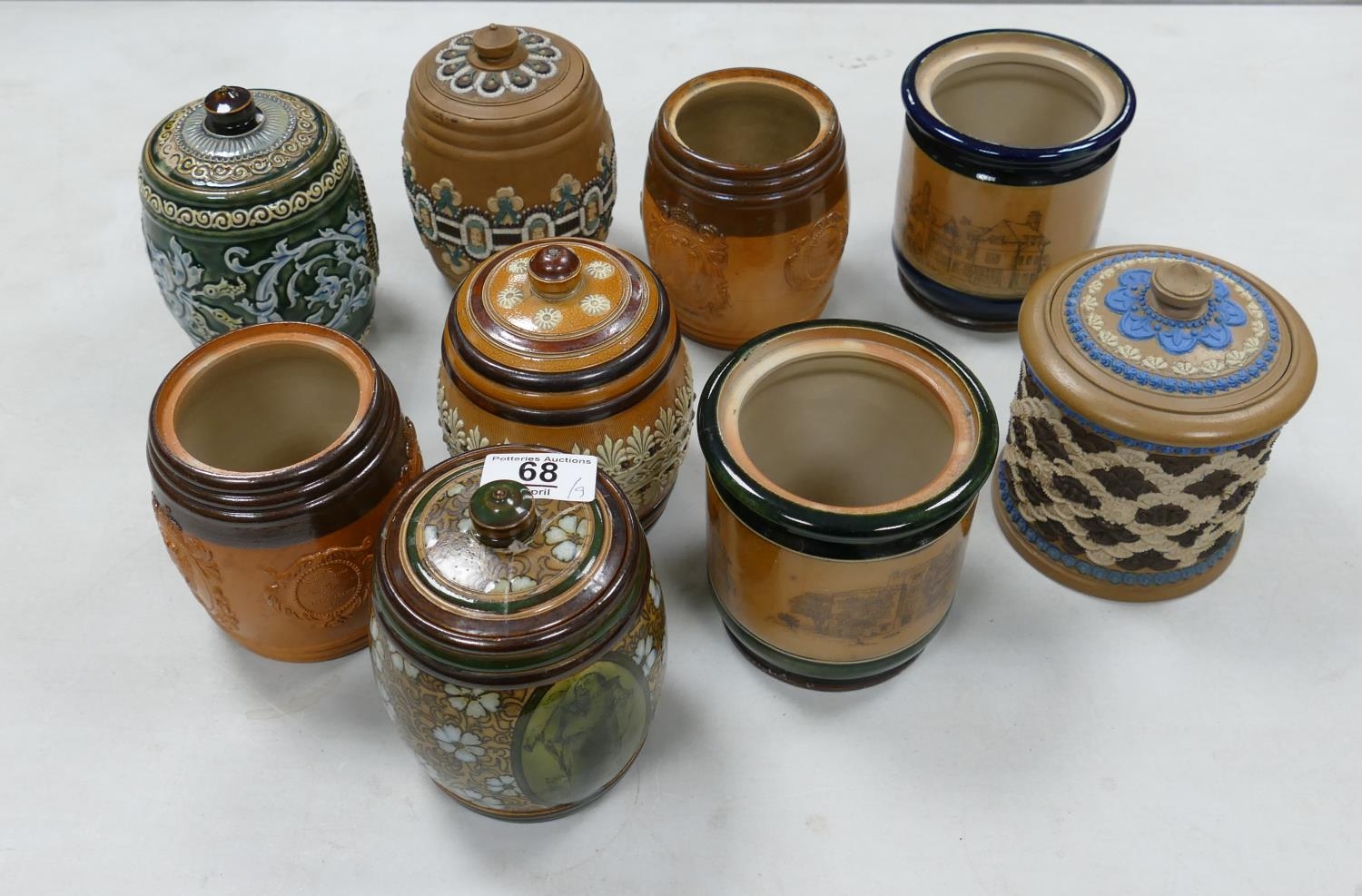 A collection of Doulton Lambeth Tobacco Jars: 4 with lids missing, 4 with damaged lids , height of