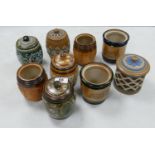 A collection of Doulton Lambeth Tobacco Jars: 4 with lids missing, 4 with damaged lids , height of