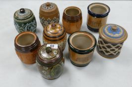 A collection of Doulton Lambeth Tobacco Jars: 4 with lids missing, 4 with damaged lids , height of