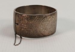 Unusually large silver bangle Chester 1960: Weight 50.7 grams, half engraved decoration. The piece