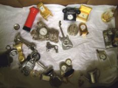 A collection of metal miniature novelty clocks: (approx 25).