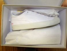 A boxed pair of Puma trainers: UK size 8 in white.