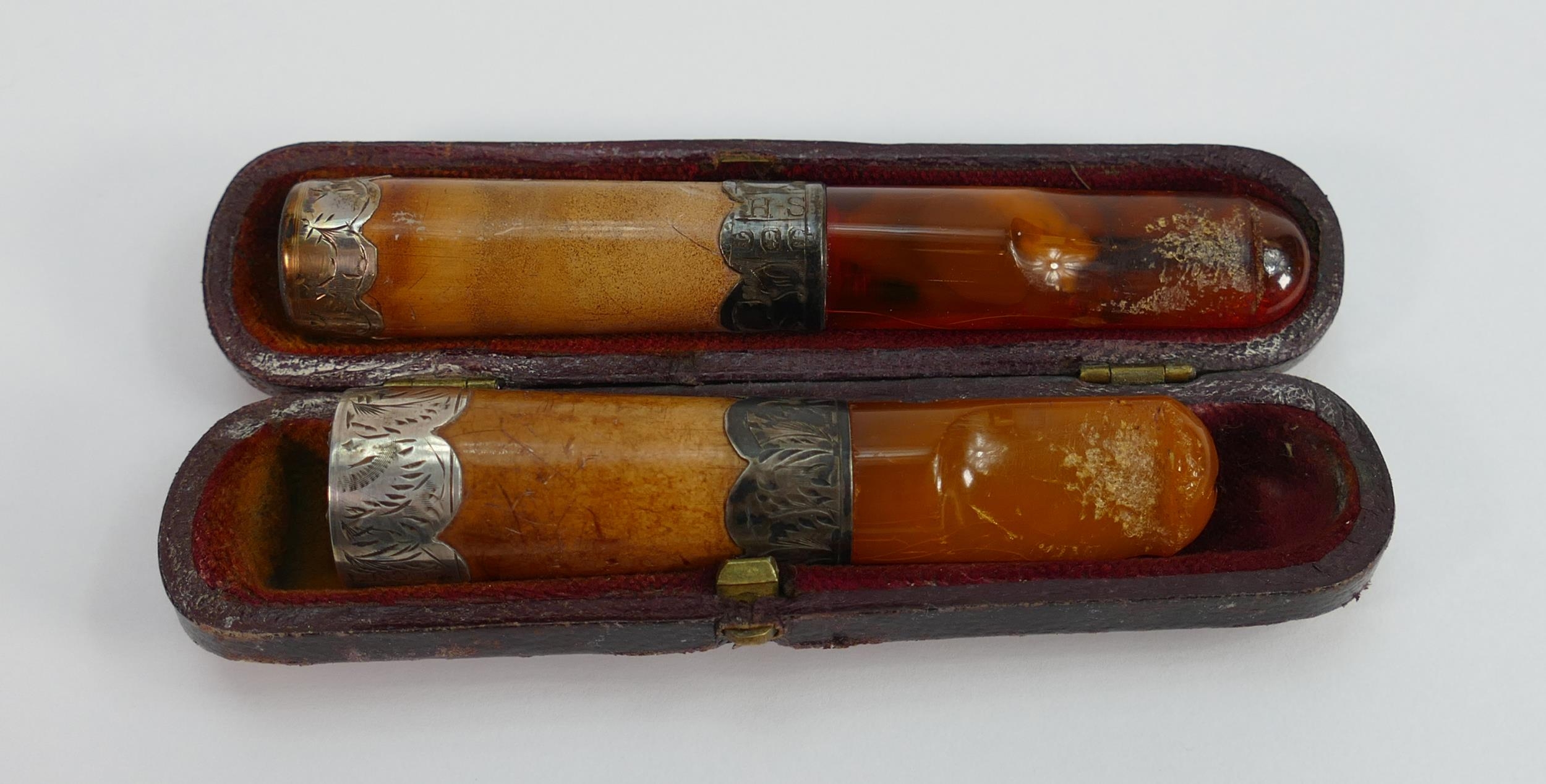Two amber Meerschaum and silver mounted cigar or cigarette holders: One in original case, largest