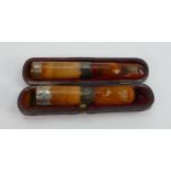 Two amber Meerschaum and silver mounted cigar or cigarette holders: One in original case, largest