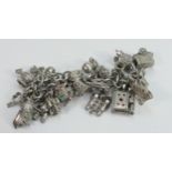 Sterling silver charm bracelet with 23 charms: a number of these charms are marked as silver in some