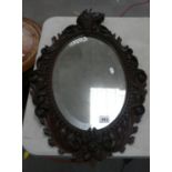 Oak carved framed bevel mirror: 74cm x 51cm