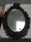 Oak carved framed bevel mirror: 74cm x 51cm