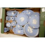 A collection of Wedgwood Blue Jasperware to include: candlesticks, lidded pots, lighters, pin