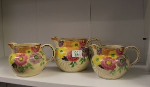 Graduated Set of Hand decorated Arthur Woods Jugs: height of tallest