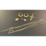 A collection of 9ct gold jewellery: to include necklace, cross pendant, belly bar, pair of ear rings