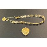 A ladies 9ct gold bracelet together with a 9ct gold heart shaped locket, total weight 6.1g.