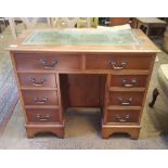 Reproduction 8 drawer leather topped desk: small proportions with locking cupboard door in the