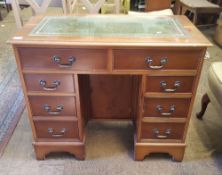 Reproduction 8 drawer leather topped desk: small proportions with locking cupboard door in the