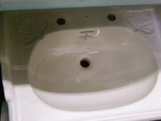 A Sanitan branded wash basin: