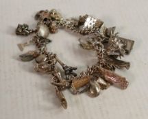 Silver charm bracelet with large quantity of charms: Some marked sterling, .925, hallmarked, ,800,