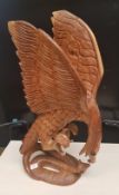 A very large African hardwood hand carved figure of an eagle and snake fighting: 79cm in height, (
