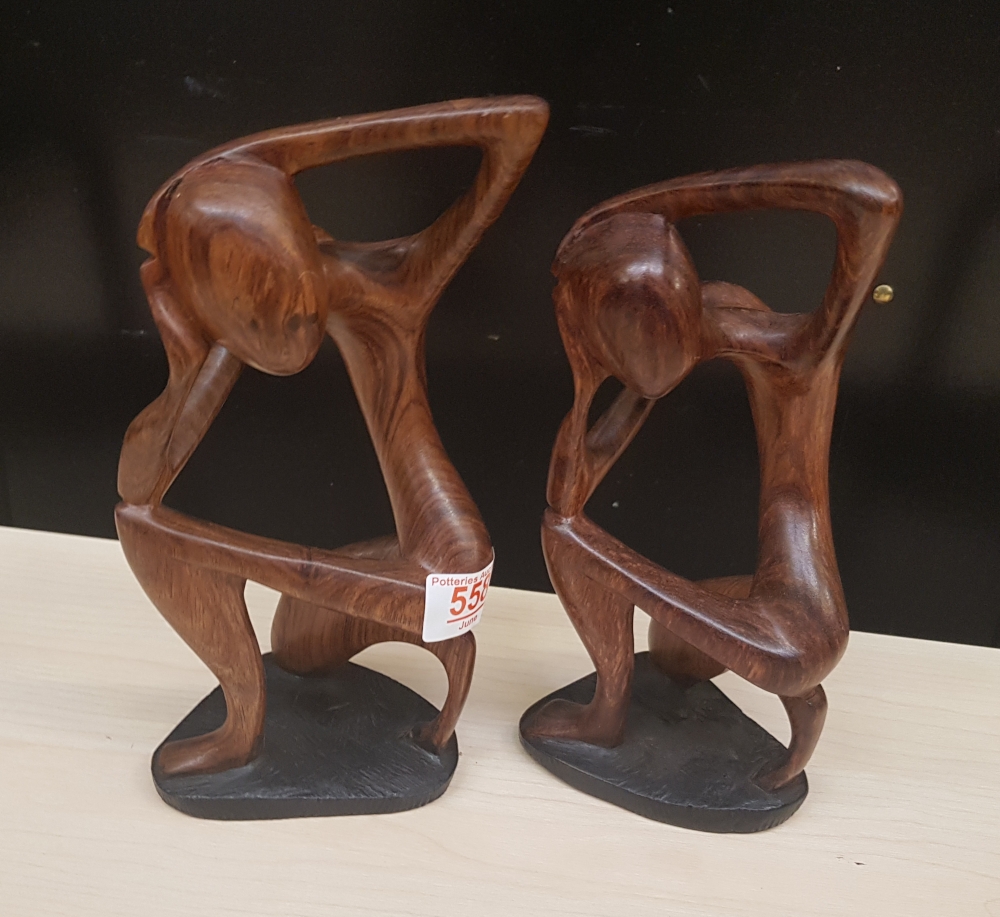 Two African hardwood hand carved stylised figures: tallest 25.5cm in height.