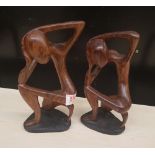 Two African hardwood hand carved stylised figures: tallest 25.5cm in height.