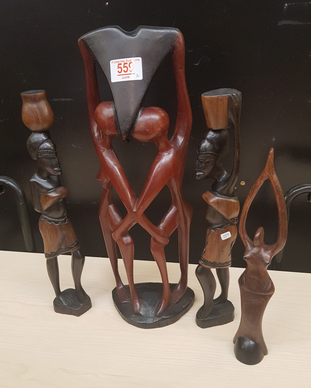 Four African hardwood hand carved stylised figures: tallest 41cm in height.