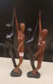 Two large African hardwood hand carved figures of stylised dancing couples: tallest 50cm in height.