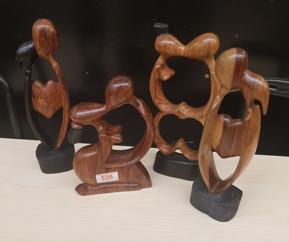 Four African hardwood hand carved stylised figures: tallest 28cm in height.