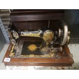 An oak cased Jones hand crank sewing machine: 258659.