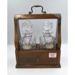 Pair of crystal decanters: with silver plated decanter labels in an oak locking tantalus (with key)