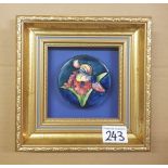 A framed Moorcroft lid Orchid pattern: overall frame size 22cm x 22cm.