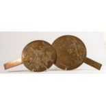 Japanese bronze paddle shaped mirrors, largest d.20cm. (2)