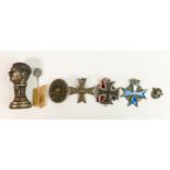 A collection of German WWII medals and badges: Comprising 1939 Iron cross, Wound badge, Eagle Tie