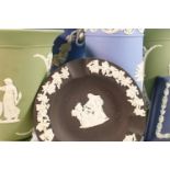 A collection of Wedgwood blue, dark blue, black & sage green items including: Vases, pin trays,