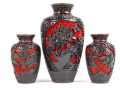 A collection of Chinese black on red cinnabar items: To include three vases, tallest 17cm. (3)