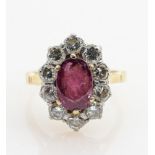 18ct gold ruby & diamond ring: Oval centre ruby surrounded by 10 diamonds, size J, 4.3g.