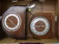 Two oak cased mantel clocks: keys and pendulums present, one has glass detached, but present.