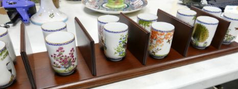 Twelve Japanese beakers: together with mahogany hanging wall shelf