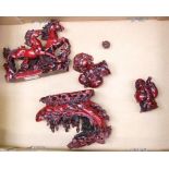 A collection of Oriental red resin figures: horses galloping, Chinese junk, Buddhas etc (1 tray).