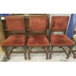 A group of three early 20th century dark oak chairs with red velvet upholstery and stretchered