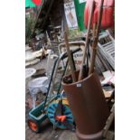 A collection of garden tools to include hose reel, seed sower, vintage and modern tool shears, rakes