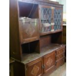 A large dark oak veneered wall unit with 2 doors and 3 drawers to the base, display unit top,