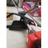 A Mountfield MB28D petrol strimmer with harness and accessories.