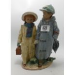 Lladro double figure group Boy and girl in raincoats: impressed number 2249, h.27.5cm.