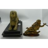 A decorative brass model of a sphinx on black slate plinth: d.16 x h.22 x L.32cm and a brass model
