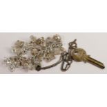 Sterling silver charm bracelet with 15 silver charms together with 1977 hallmarked silver key